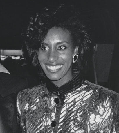 Black and white magazine photo of Iris Simpson, smiling confidently