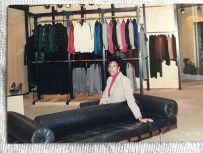 Iris poses from the black leasther couch at a YSL store in Hazelton Lanes Shopping Centre