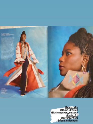 Model wearing layered, colorful fashion with intricate embroidery and textured accessories.