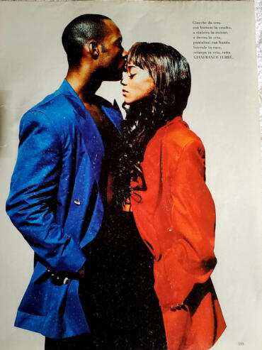 Fashion photograph of a man and woman in colorful jackets, close and intimate.