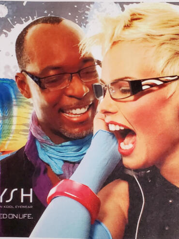 Two friends sharing a joyful moment, wearing stylish glasses and colorful accessories.