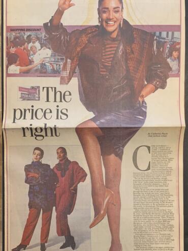 A woman in a leather jacket, striped top, and leather skirt, smiling and waving, is featured on this 1987 fashion newspaper cover.