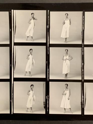 Black and white, test photo shoot contact sheet of Denise wearing a white, sleeveless dress, long dress