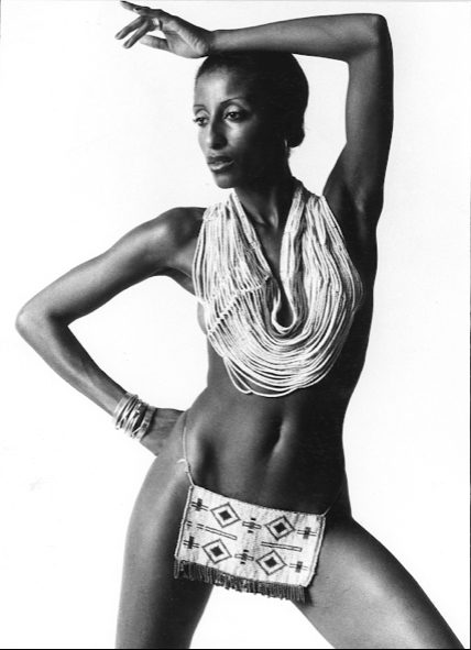Elegant necklace and patterned hip bag paired with striking black-and-white portrait.