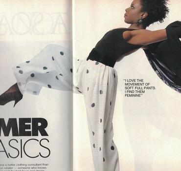 Model in polka dot pants strikes a dynamic pose in a fashion magazine.
