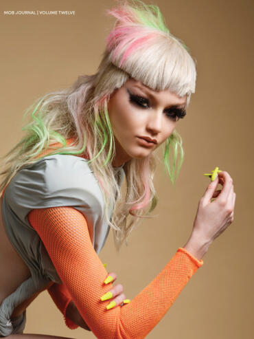 Fashion model with pastel-colored hair and bold nails poses for MOB Journal cover.