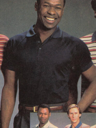 Group of diverse men, smiling and posing, dressed casually.