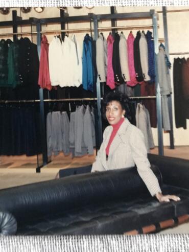 Iris poses from the black leasther couch at a YSL store in Hazelton Lanes Shopping Centre