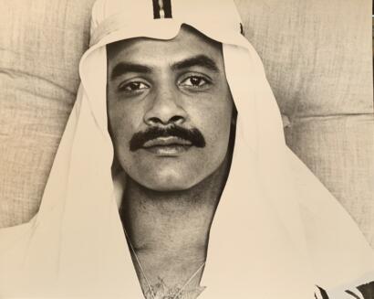 Portrait of a man with a mustache, wearing a traditional headdress, in black and white.