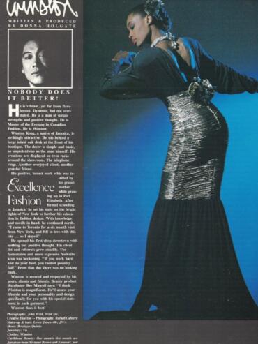 Model in a black silk jersey 'exit-maker' dress with gold silk sash, posing against a blue background.