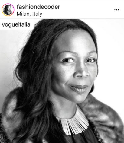 Portrait of a woman in Milan, Italy, wearing a stylish fur-lined coat and statement necklace.