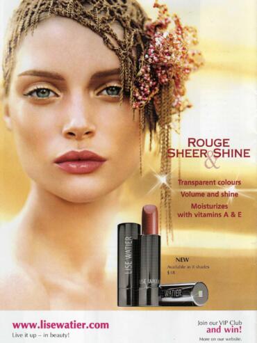 Close-up of a woman with styled hair and makeup, promoting LiSe Watier's Sheer Shine lipstick.