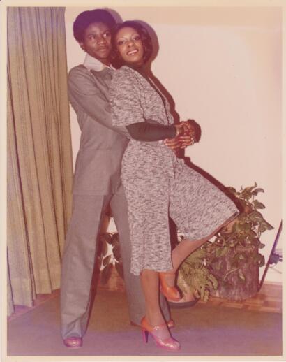 Vintage photo of two women posing indoors, dressed in stylish 1980s fashion.