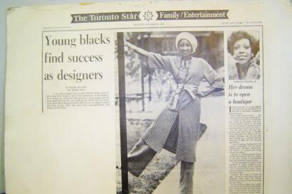 Vintage newspaper clipping of Lorraine Delsol, a young Black woman, posing confidently outdoors in a striped dress and headwrap, highlighting her dream to open a boutique.