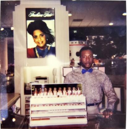 Fashion store display with a man in a patterned shirt and blue bowtie.