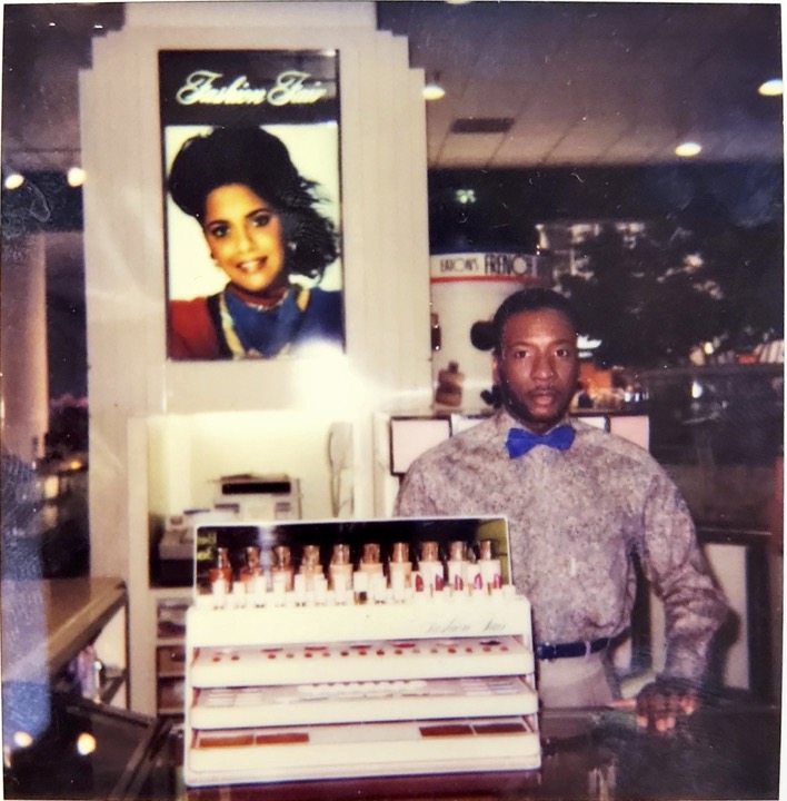 Fashion store display with a man in a patterned shirt and blue bowtie.