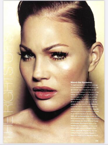 Close-up of a woman's face showcasing dramatic eye makeup with false eyelashes, mascara, and eye shadow.