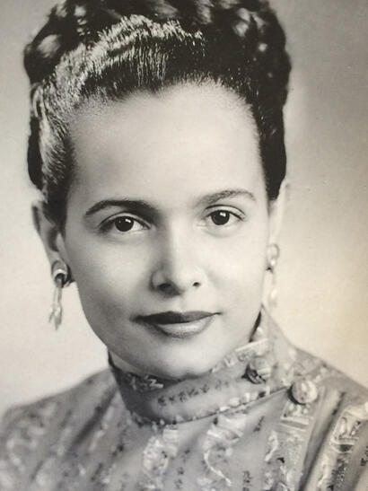 Vintage black-and-white portrait of a woman with elegant hairstyle and jewelry, exuding timeless grace.