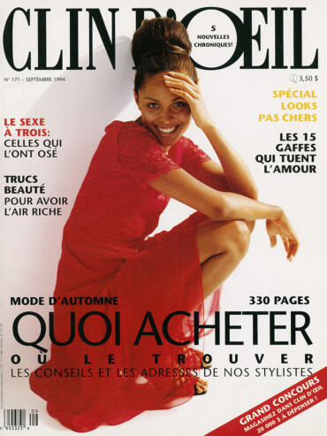 Cover of Clin D’Oeil magazine featuring a smiling woman in a red dress, with bold headlines in French.