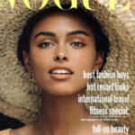 Vogue Australia cover featuring a woman wearing a wide-brimmed straw hat, with headlines about fashion, travel, fitness, and beauty.
