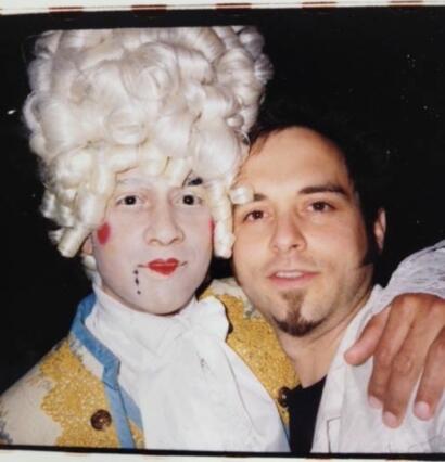 Person dressed as Marie Antoinette with elaborate wig and makeup, posing with a man.