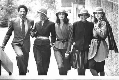 Group of stylish women and man walking outdoors in vintage-inspired fashion.