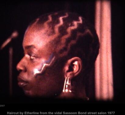 Close-up of a woman with elaborate braided hairstyle and bold lightning bolt face paint.