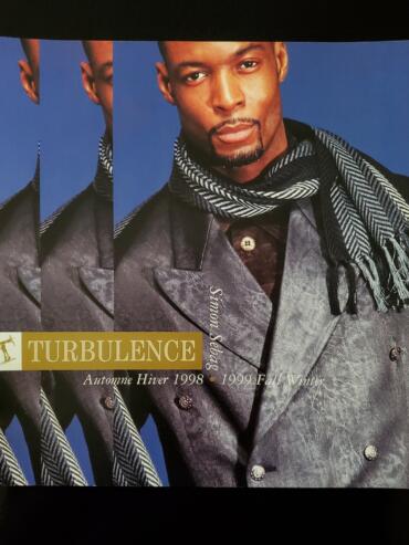 Magazine cover featuring a male model in a winter coat with scarf, promoting fall/winter 1998-1999 fashion.