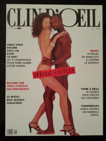 A magazine cover featuring a diverse couple embracing, highlighting themes of love and intimacy.