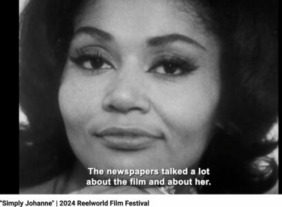 Close-up of a woman with glamorous makeup, classic hairstyle, black-and-white, with caption overlay.