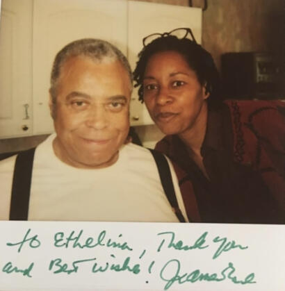 A heartfelt thank you note written on a photo, featuring two smiling individuals in a cozy indoor setting.