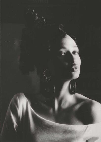 Portrait of an elegant woman with vintage earrings in monochrome, showcasing timeless style.