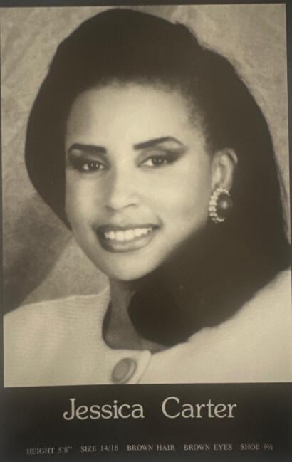 Black-and-white portrait of Jessica Carter, a woman with dark hair, bold makeup, and elegant earrings.