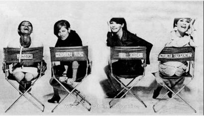Black and white photo of four women sitting on director's chairs, smiling and posing.