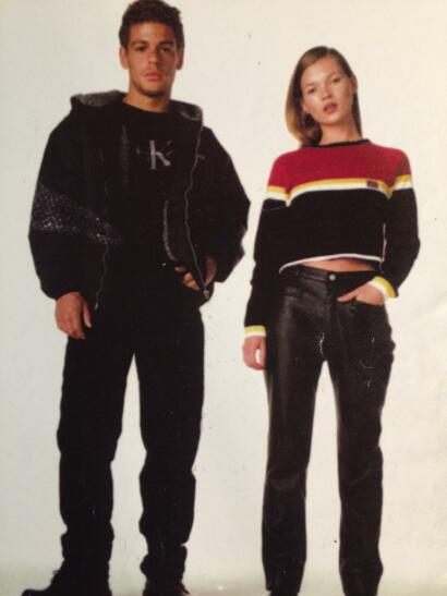 Young man and woman in casual streetwear pose against a white background, showcasing modern fashion style.
