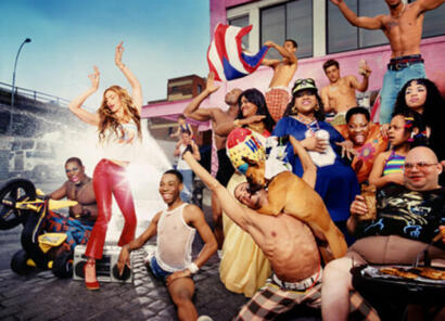 A vibrant outdoor gathering featuring diverse individuals in colorful summer outfits.
