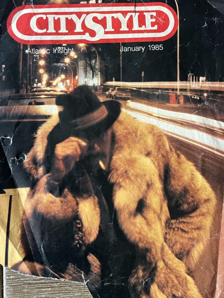 Vintage magazine cover featuring a man in a coat and hat with two puppies at night.