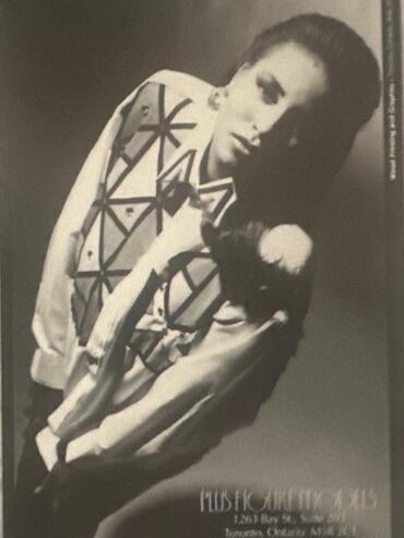 Fashion magazine-style photo of a woman in a geometric-patterned jacket, with contact details at the bottom.