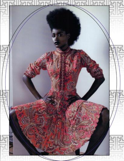 Fashion model wearing a vibrant, paisley-patterned dress with puffed sleeves, striking black lipstick.